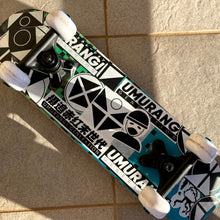 Load image into Gallery viewer, A skateboard featuring Umurangi Generation stickers