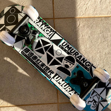 Load image into Gallery viewer, A skateboard featuring Umurangi Generation stickers

